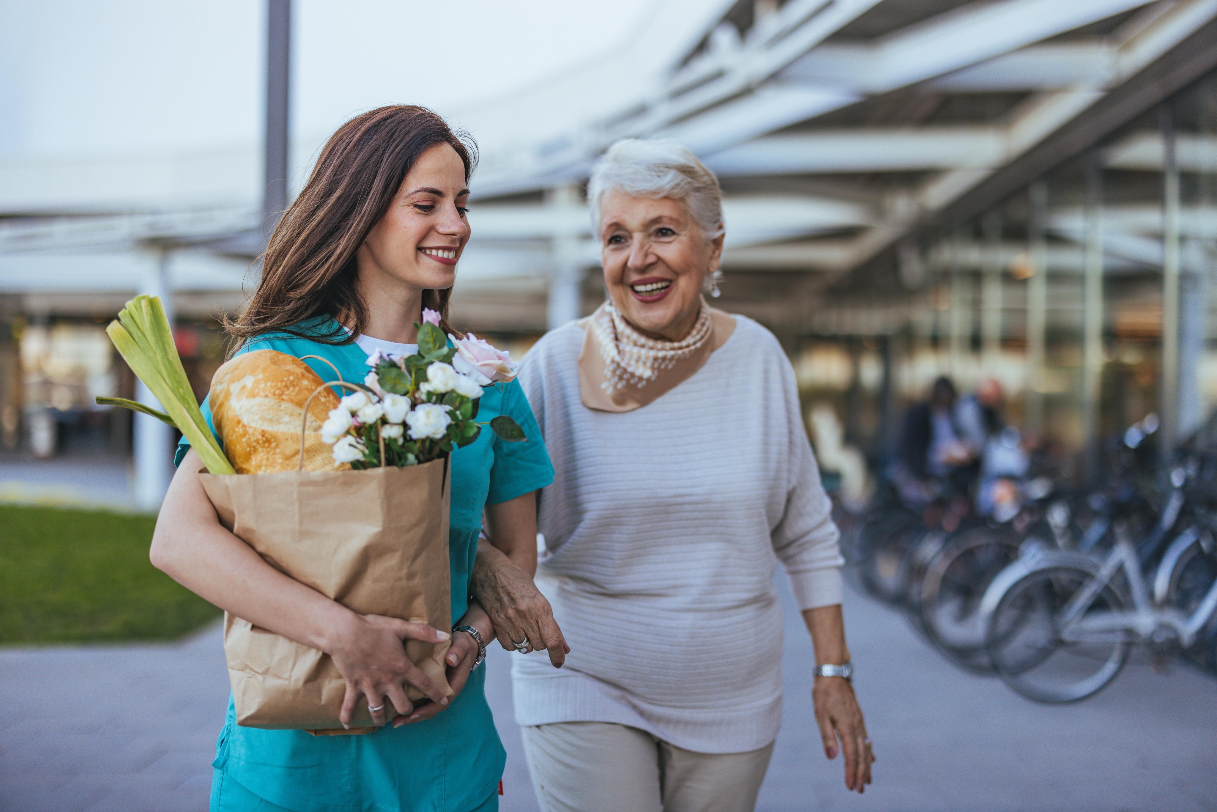 Nurse providing compassionate care to an elderly person at home